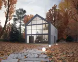 Maison moderne avec un grand pignon vitré, entourée d'arbres aux couleurs d'automne. Un chemin de dalles mène à la porte d'entrée.