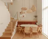 Plan salle à manger avec banquette, table ovale et chaises en rotin. Escalier en bois à gauche.