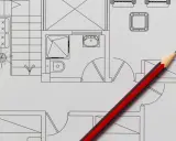 Un crayon rouge et noir sur un plan de maison, idéal pour faire un plan de maison gratuit et visualiser votre projet.