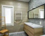 Salle de bain moderne avec murs en bois clair et pierre grise. Un meuble vasque en bois, un miroir, un radiateur et une échelle en bambou pour habiller un mur.
