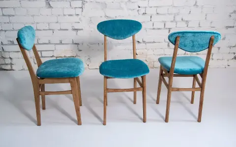 Trois chaises en bois relookées avec un tissu bleu turquoise velouté. Une belle idée déco pour transformer de vieilles chaises.