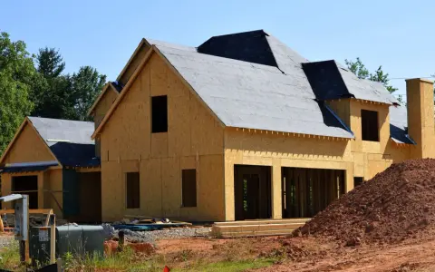 Construction d'une maison en bois, prête à moderniser une maison existante. Le toit est recouvert de feutre, les murs sont en panneaux OSB.