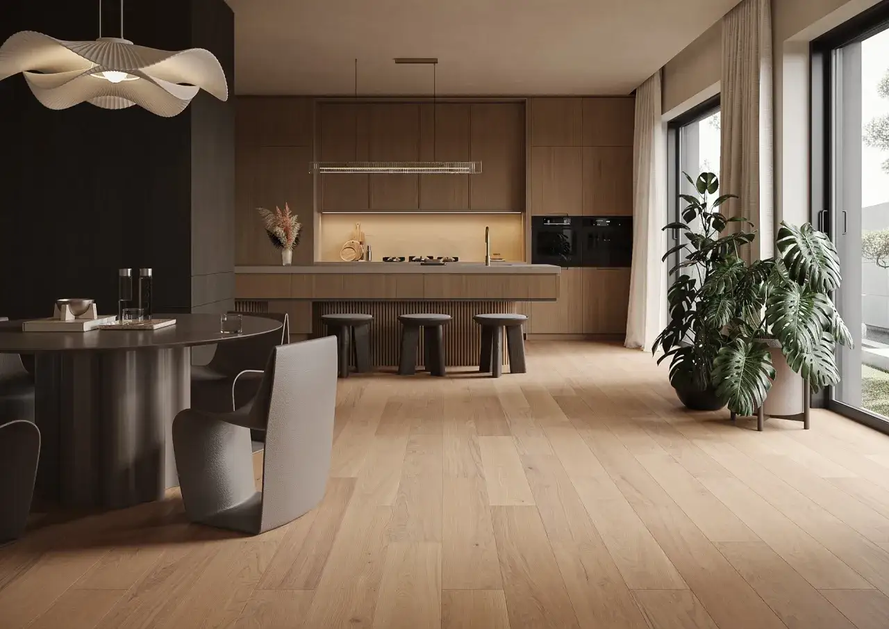 Un salon-cuisine moderne avec un nouveau revêtement sol en bois clair. Une table ronde et des chaises design font face à une cuisine épurée.