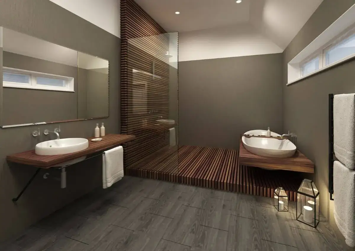 Salle de bain moderne avec douche sur plancher bois, lavabo suspendu et baignoire îlot. Ambiance zen et naturelle.