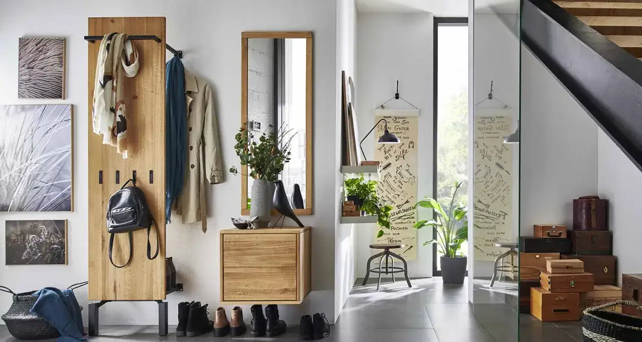 Idée pour aménager entrée étroite : porte-manteau mural en bois, miroir, banc et rangements astucieux pour un espace fonctionnel et stylé.