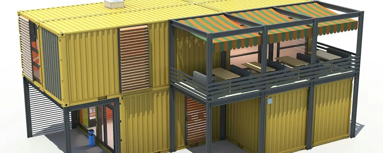 Une maison conteneur moderne à deux étages avec un espace extérieur aménagé pour manger.